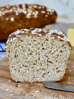 A sliced loaf of Buttermilk Sourdough showing the open and textured inner crumb.