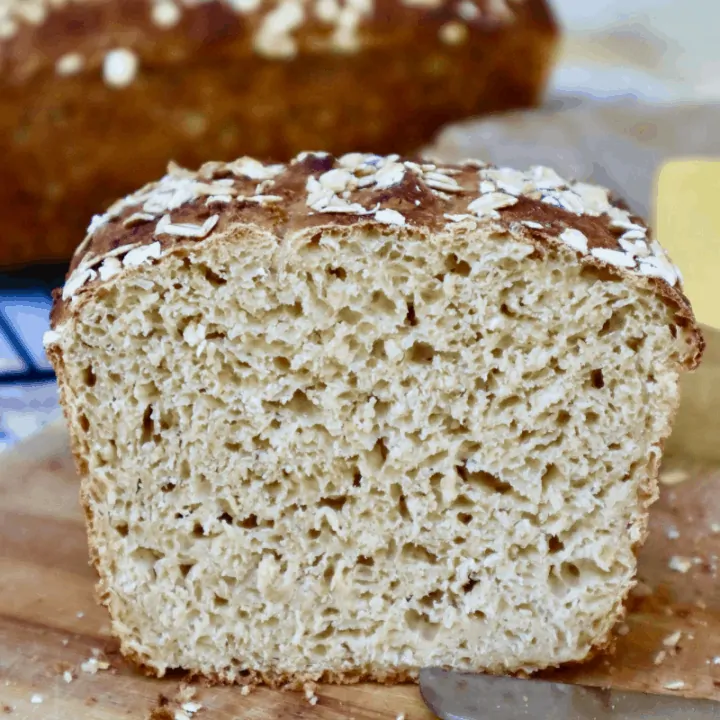 A sliced loaf of Buttermilk Sourdough showing the open and textured inner crumb.