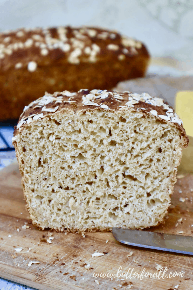 A sliced loaf of Buttermilk Sourdough showing the open and textured inner crumb.