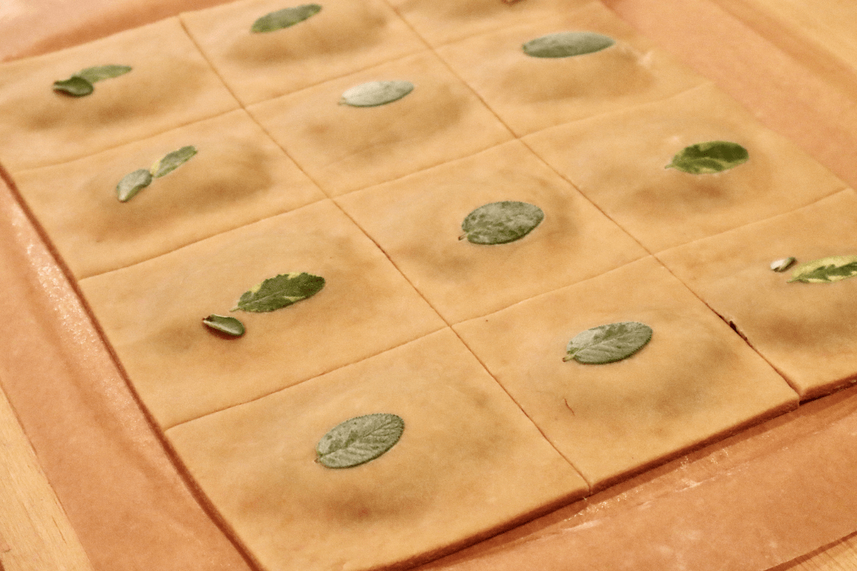 The dough is now cut in 12 even squares with the filling directly in the middle of each square.