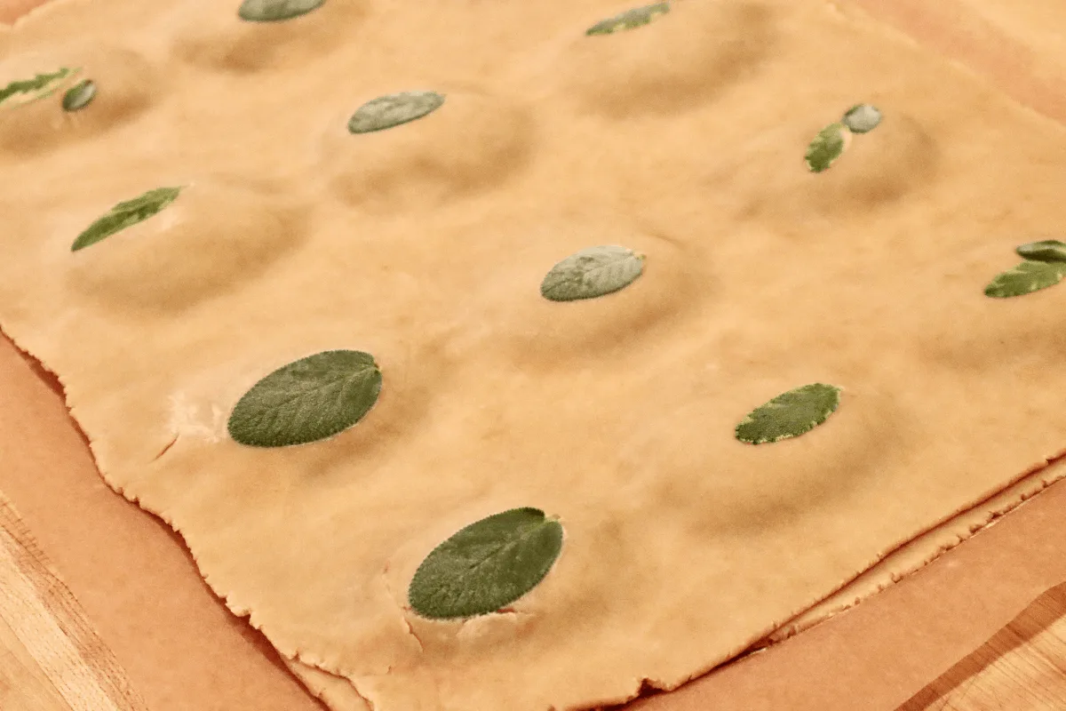 The pastries are now topped with the second sheet of dough.