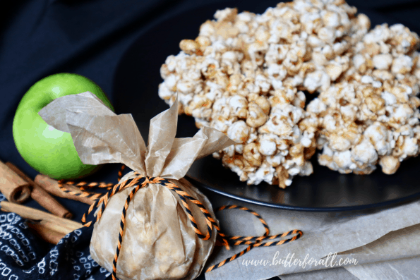 Plate of Cinnamon Apple Honey-Butter Caramel Popcorn Balls with festive decorations.