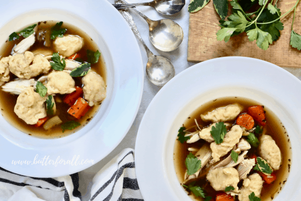 Two bowls of Chicken and Dumpling Soup with big, soft, pillowy sourdough dumplings. 