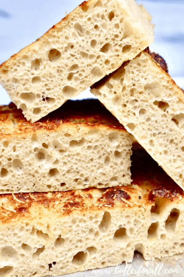A stack of cut focaccia showing the open crumb structure.