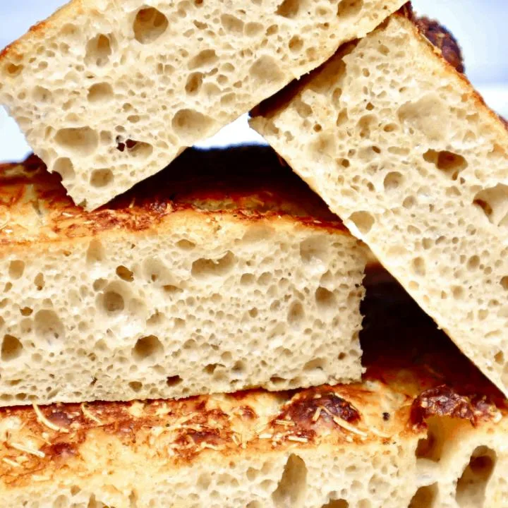 A stack of cut Focaccia show the open crumb structure.