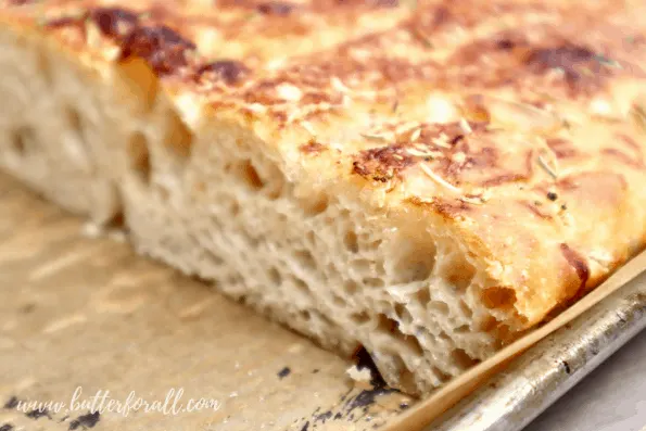 Close-up of the focaccia in the pan with crispy edge.