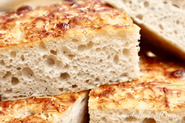 Close-up of the open crumb on the focaccia dough.