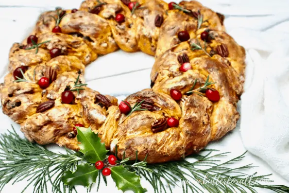 A braided sourdough wreath with festive decorations.