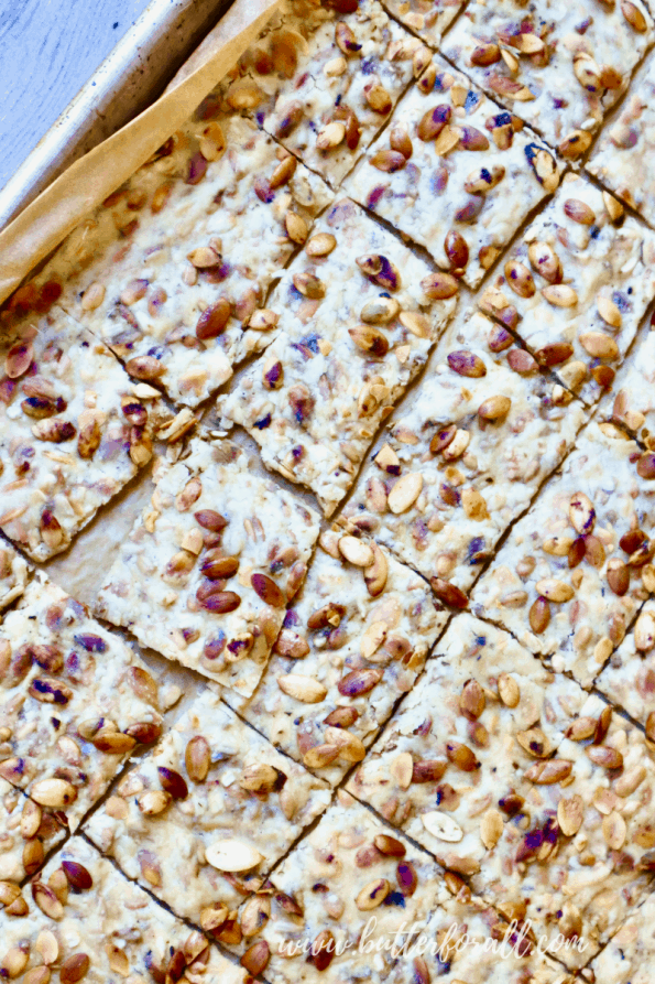 A baking sheet with scored and baked sprouted seed sourdough crackers.