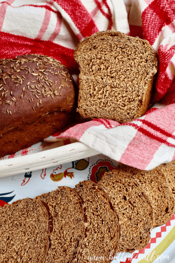 Close-up of a sourdough rye loaf cut to reveal the perfect, even, dark brown crumb.