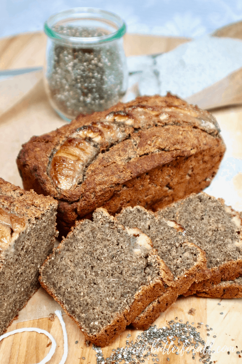 Freshly baked and sliced buckwheat banana bread with a jar of chia seeds.