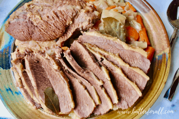 A large platter with freshly cooked and sliced homemade corned beef.