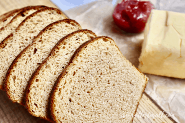 Perfectly sliced Kamut sourdough bread with butter and jam.