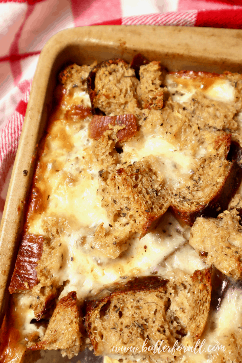Savory sourdough bread pudding with a golden brown top.