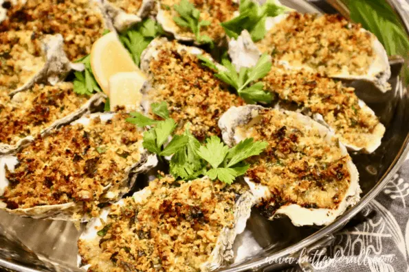 A pan of freshly baked sourdough-crusted oysters Rockefeller on the half shell.