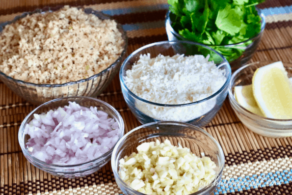 Bowls of sourdough breadcrumbs, Parmesan cheese, minced shallots, minced garlic, parsley, and lemon. 