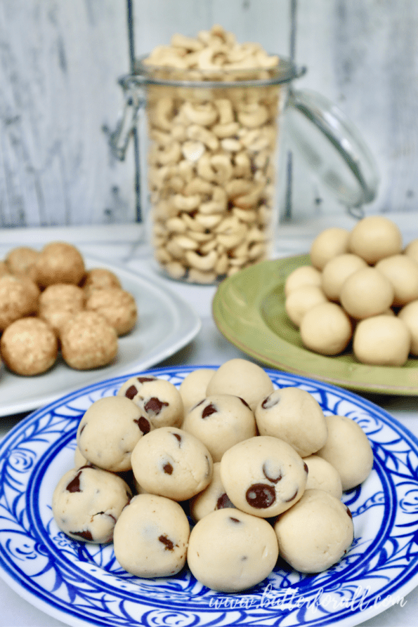 Plates of cashew cookie dough bites and a jar full of whole raw cashews. 