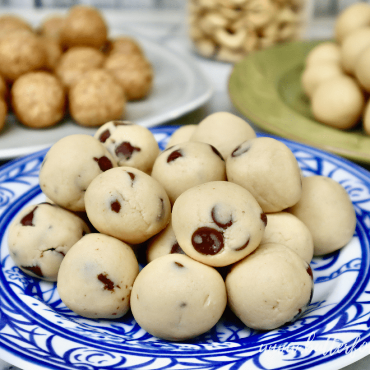 Colorful plates filled with cashew cookie dough bites in a variety of flavors.