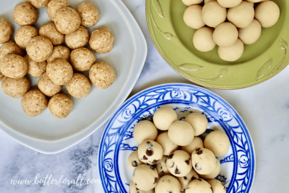 Overhead view of plates piled high with cashew cookie dough bites. 