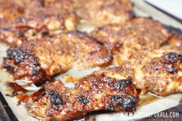 A sheet pan with perfectly roasted honey mustard chicken thighs.