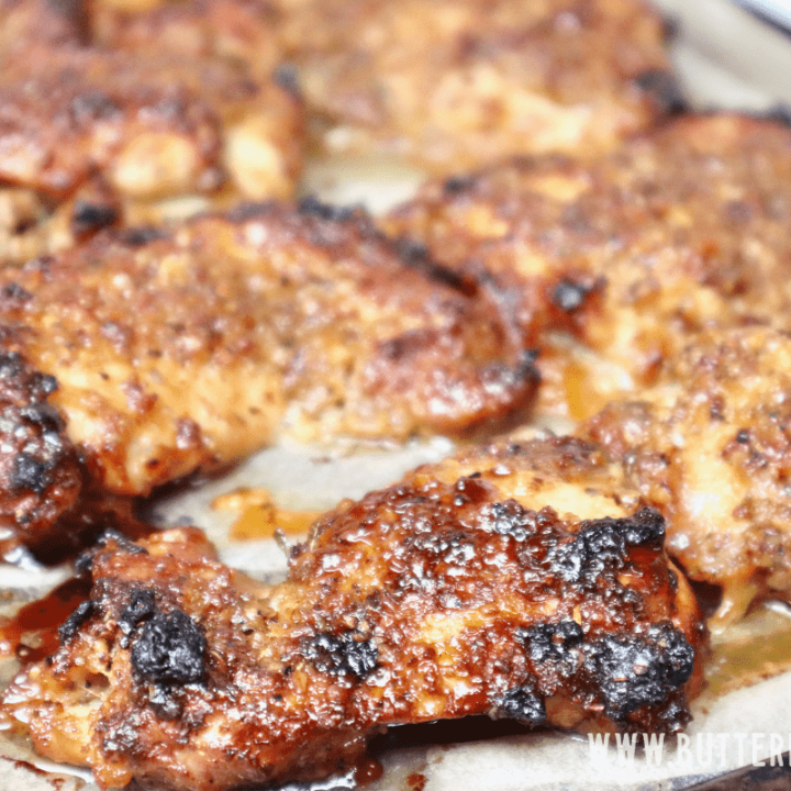 A sheet pan with perfectly roasted honey mustard chicken thighs.