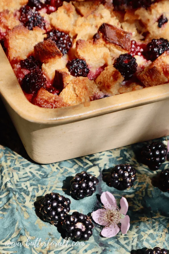 Golden-brown sourdough bread pudding studded with juicy blackberries. 
