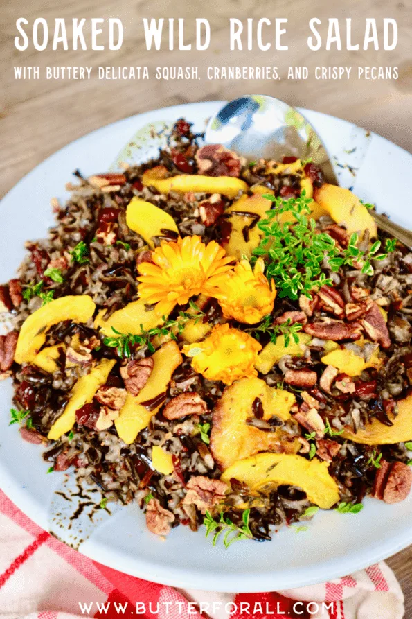 Title text with image of soaked wild rice salad topped with flowers and fresh herbs.