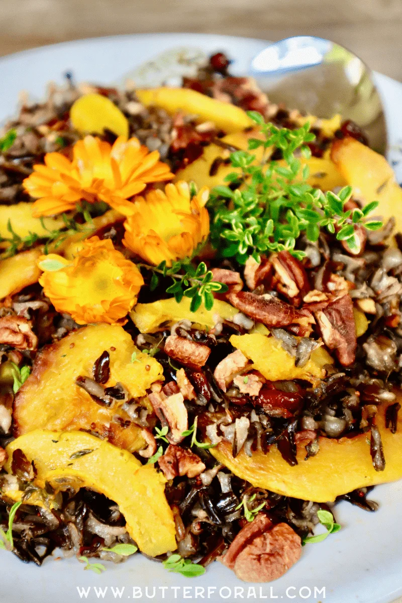 Soaked wild rice salad topped with flowers and fresh herbs.