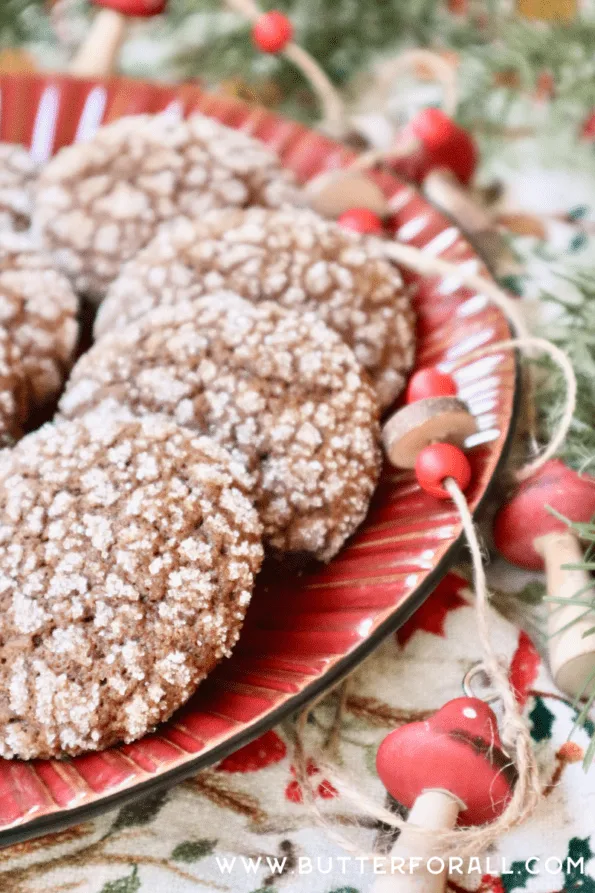 A plate of glittery, sugar coated sourdough crinkle cookies with festive mushroom and bead garlands.