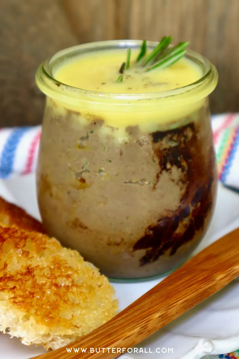 A jar of Rabbit Liver Pâté with balsamic swirls, clarified butter cap, and sprig of rosemary.