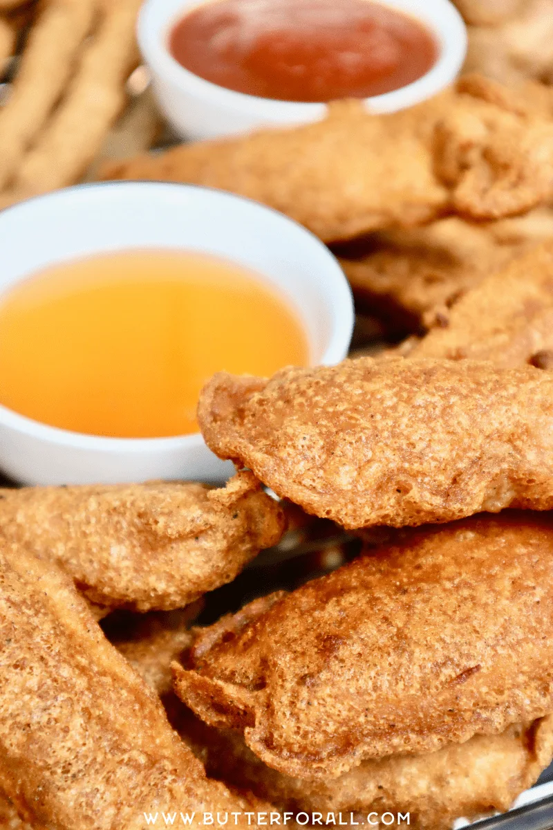Golden fried chicken strips with honey dipping sauce.
