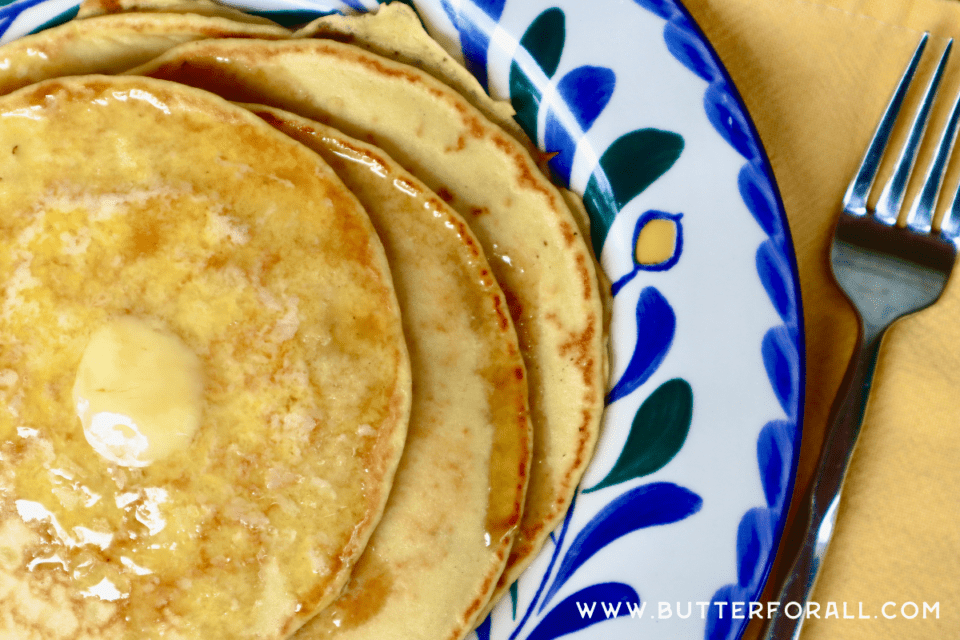 Einkorn sourdough pancakes with melted butter on a plate.