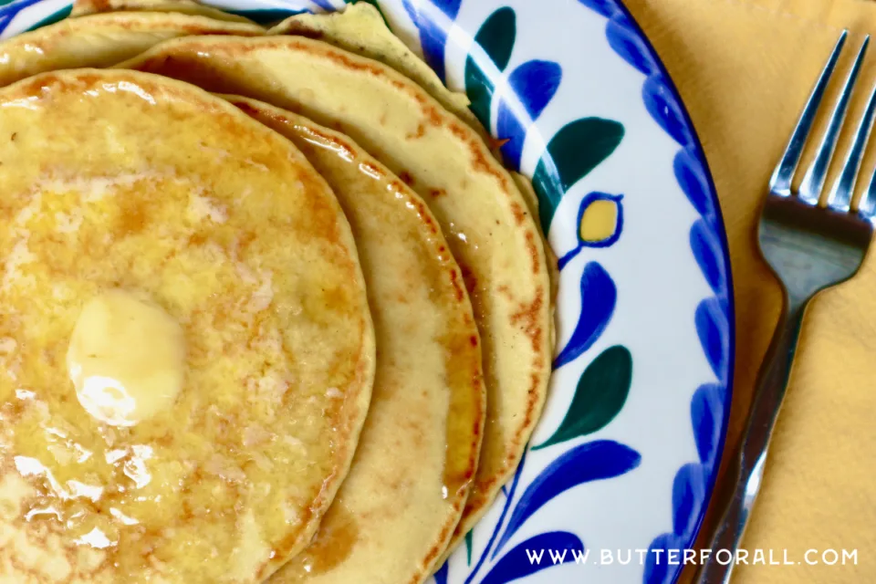 Einkorn sourdough pancakes with melted butter on a plate.