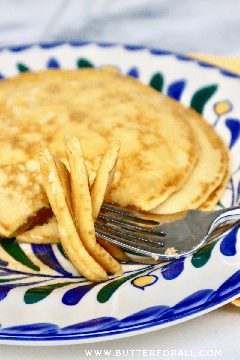 Tender layers of golden einkorn pancakes on a fork.