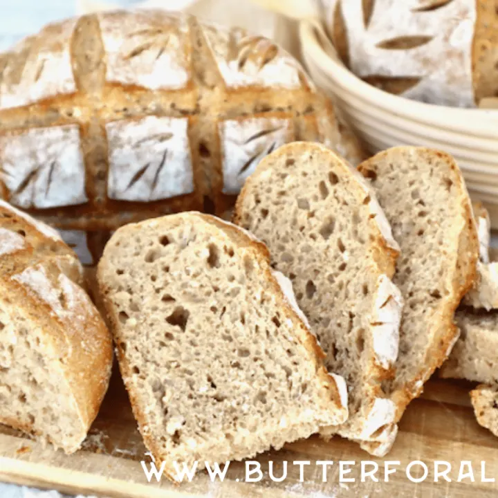 Slices of seven-grain sourdough bread showing the open even crumb and golden crust.