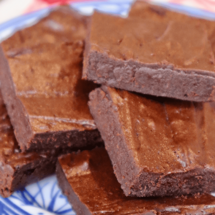 A plate stacked with shiny einkorn sourdough brownies.