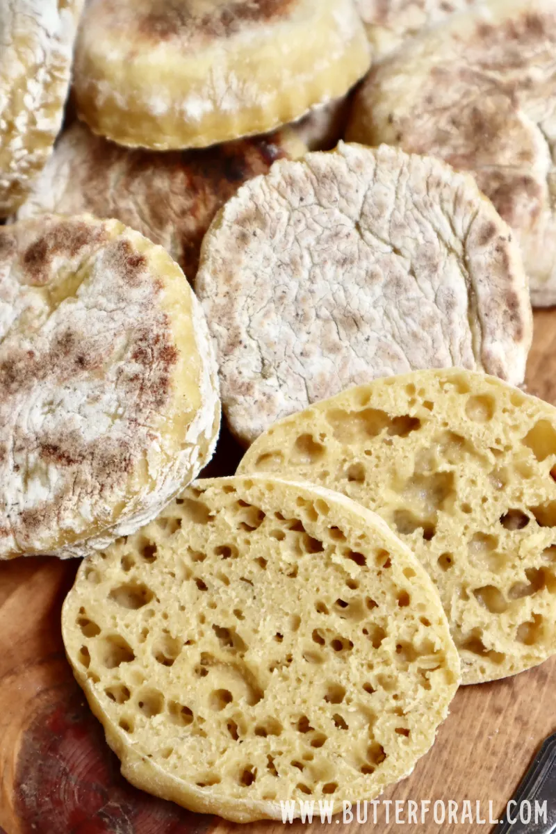 Golden-colored English muffins sliced in half to reveal tons of nooks and crannies. 