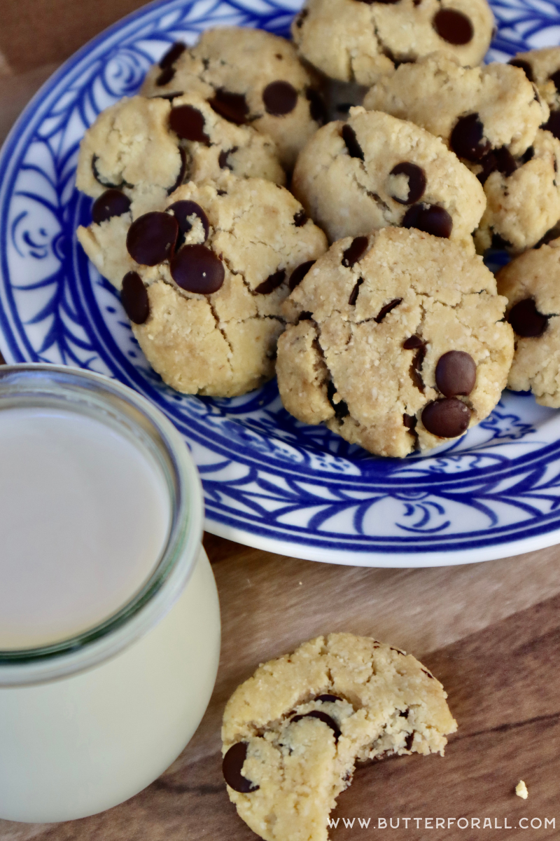 A plate of almond flour carob chip cookies with a glass of cold milk.