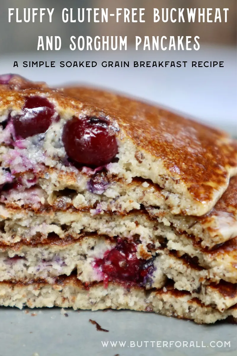 A stack of fluffy pancakes that have been cut into with a fork, exposing juicy blueberries.